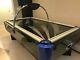 Air hockey table, black and blue. Used but not regularly